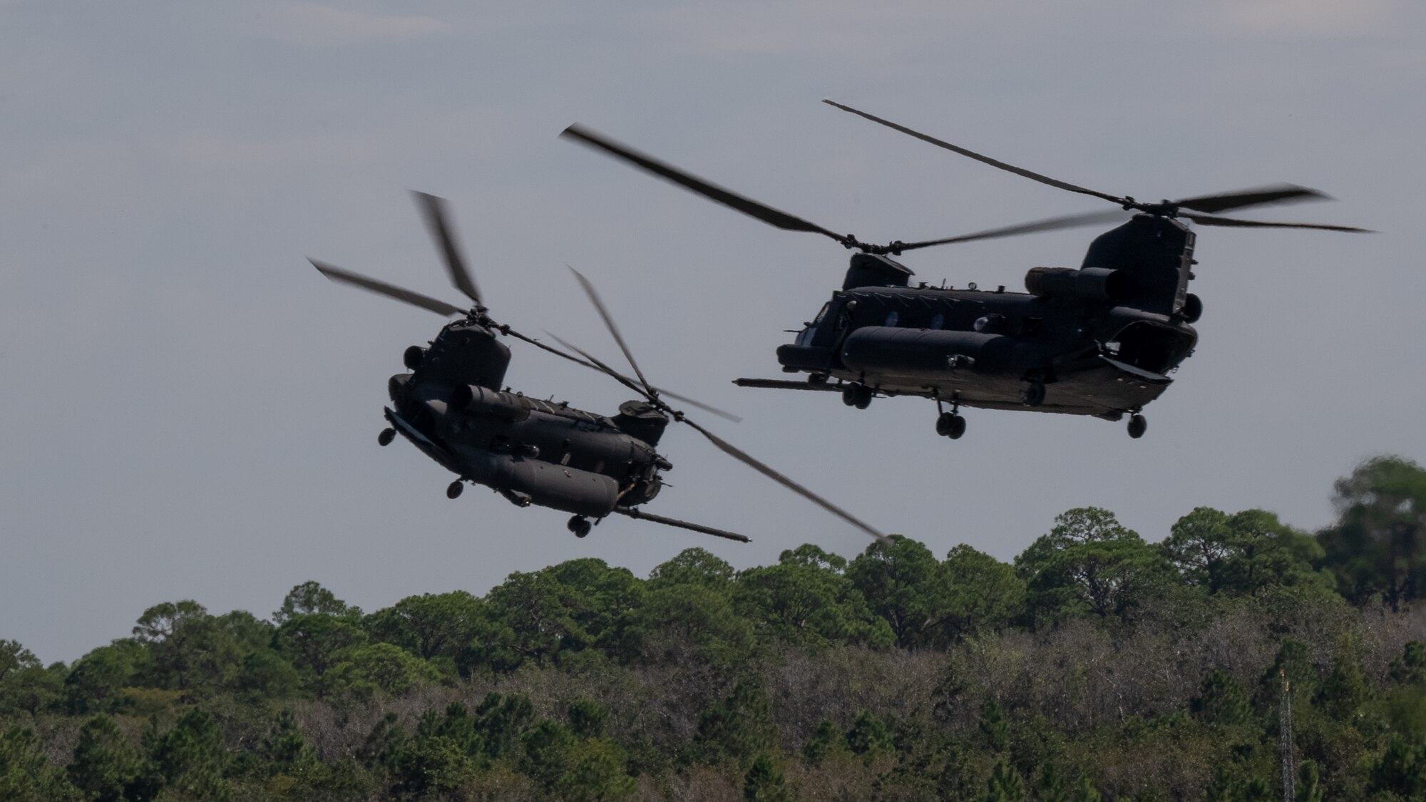 U.S. Army MH-47G Chinook helicopters assigned to the 160th Special Operations Aviation Regiment fly during the 94th Joint Civilian Orientation Conference at Hurlburt Field, Florida, Sept. 21, 2023. JCOC is the Department of Defense’s public liaison program, designed to provide American business and community leaders with a deeper understanding of the military by showcasing the rewards and challenges service members face both on and off the battlefield. (U.S. Air Force photo by Airman 1st Class Hussein Enaya)