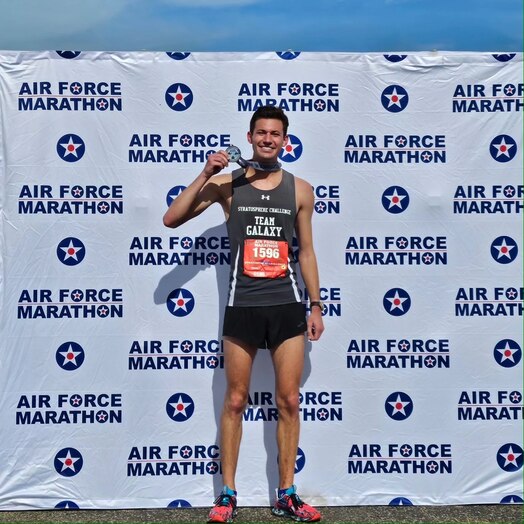  U.S. Space Force 1Lt Ryan Kirk poses with his Air Force Marathon finishers medal at Wright-Patterson Air Force Base, Ohio, Sept. 16, 2023. Running on behalf of the Department of the Air Force Sports program, Kirk finished the 26.2-mile race in 2:57:14.