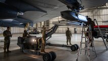 Airmen assigned to the 5th Aircraft Maintenance Squadron work together to load an inert AGM-86 air-launched cruise missile onto a B-52H Stratofortress during the 3rd Quarter Load Crew Competition at Minot Air Force Base, North Dakota Oct. 2, 2023. These Airmen were tasked to load the inert AGM-86 onto the B-52H Stratofortress as fast and efficiently as possible while also maintaining all safety precautions.