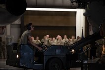 Airman 1st Class Timothy McDonald, 5th Aircraft Maintenance Squadron weapons load crew member, uses a missile carrier to load an inert precision guided munition onto a B-52H Stratofortress at Minot Air Force Base, North Dakota, Oct. 2, 2023. McDonald engaged in the 3rd Quarter Load Crew competition which assessed efficiency in loading an inert munition onto a B-52H Stratofortress.