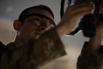 Senior Airman Matthew McMahon, 5th Aircraft Maintenance Squadron weapons load crew member, attaches an inert precision guided munition to the wing pylon of a B-52H Stratofortress at Minot Air Force Base, North Dakota, Oct. 2, 2023. McMahon was on a team competing in the 3rd Quarter Load Crew Competition which required them to complete a written test and load an inert missile onto a B-52H Stratofortress quickly and efficiently.