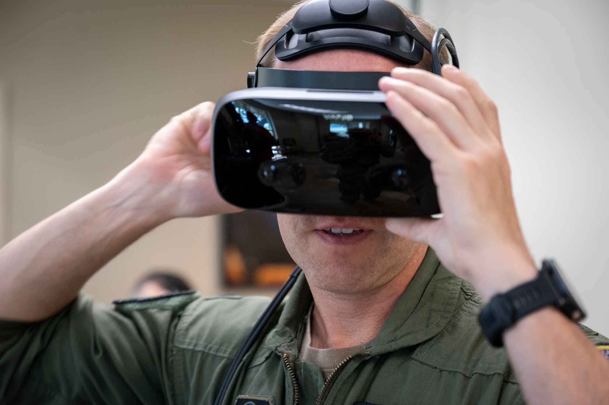 An Air Commando tries on a Virtual Reality headset during an XR demonstration at the 2023 Weapons and Tactics Conference on August 16, 2023. With a comprehensive XR Training Framework in place, AFSOC is poised to transform its training methodologies, ensuring that Air Commandos are better prepared and equipped for strategic competition. (U.S. Air Force photo by Staff Sgt. Caleb Pavao)