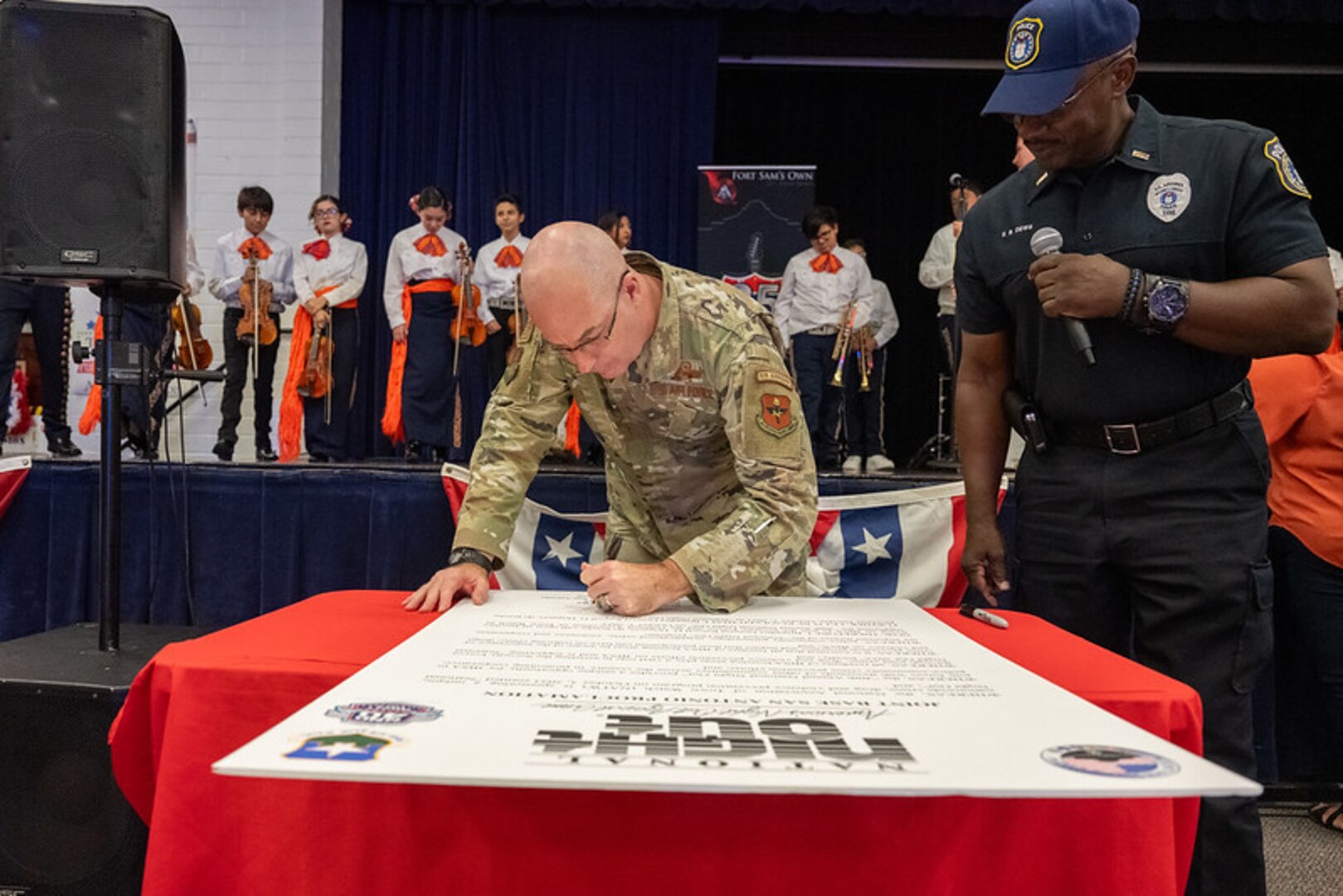 Military member signing poster.