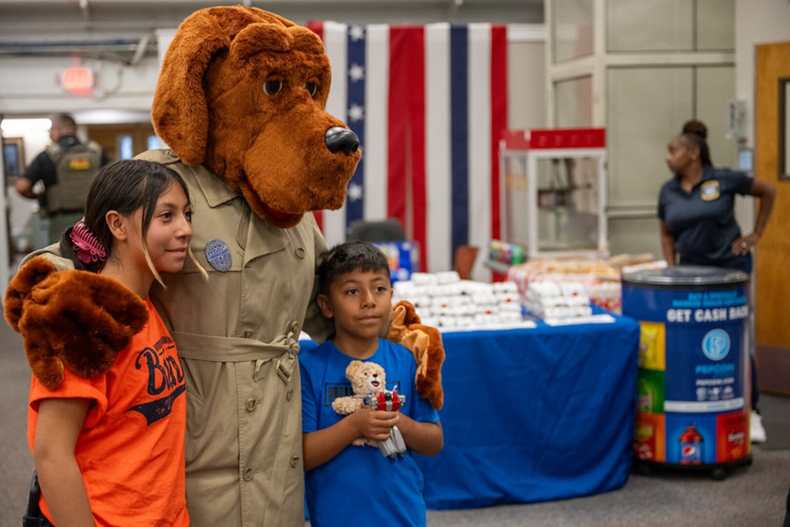 McGruff the crime dog (in costume) poses with children.