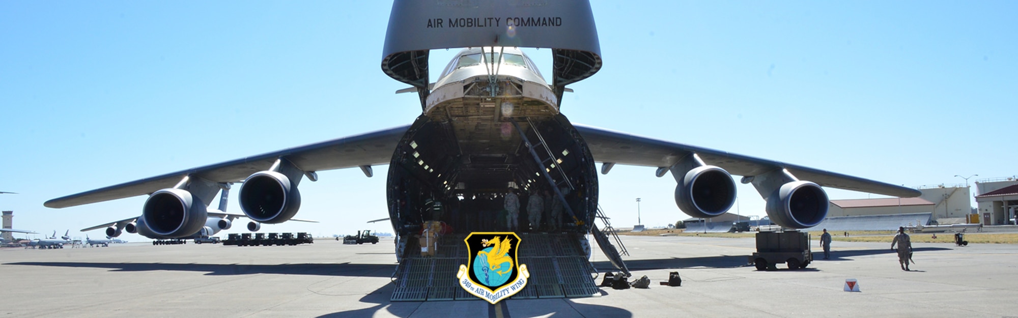A C-5M Super Galaxy sits with its nose open on the flightline July 15, 2018 at Travis Air Force Base, Calif. The trainees of the Development and Training Flight toured the aircraft to become familiarized with the 349th Air Mobility Wing’s mission. (U.S. Air Force photo by Tech. Sgt. Christopher Carranza/Released)
