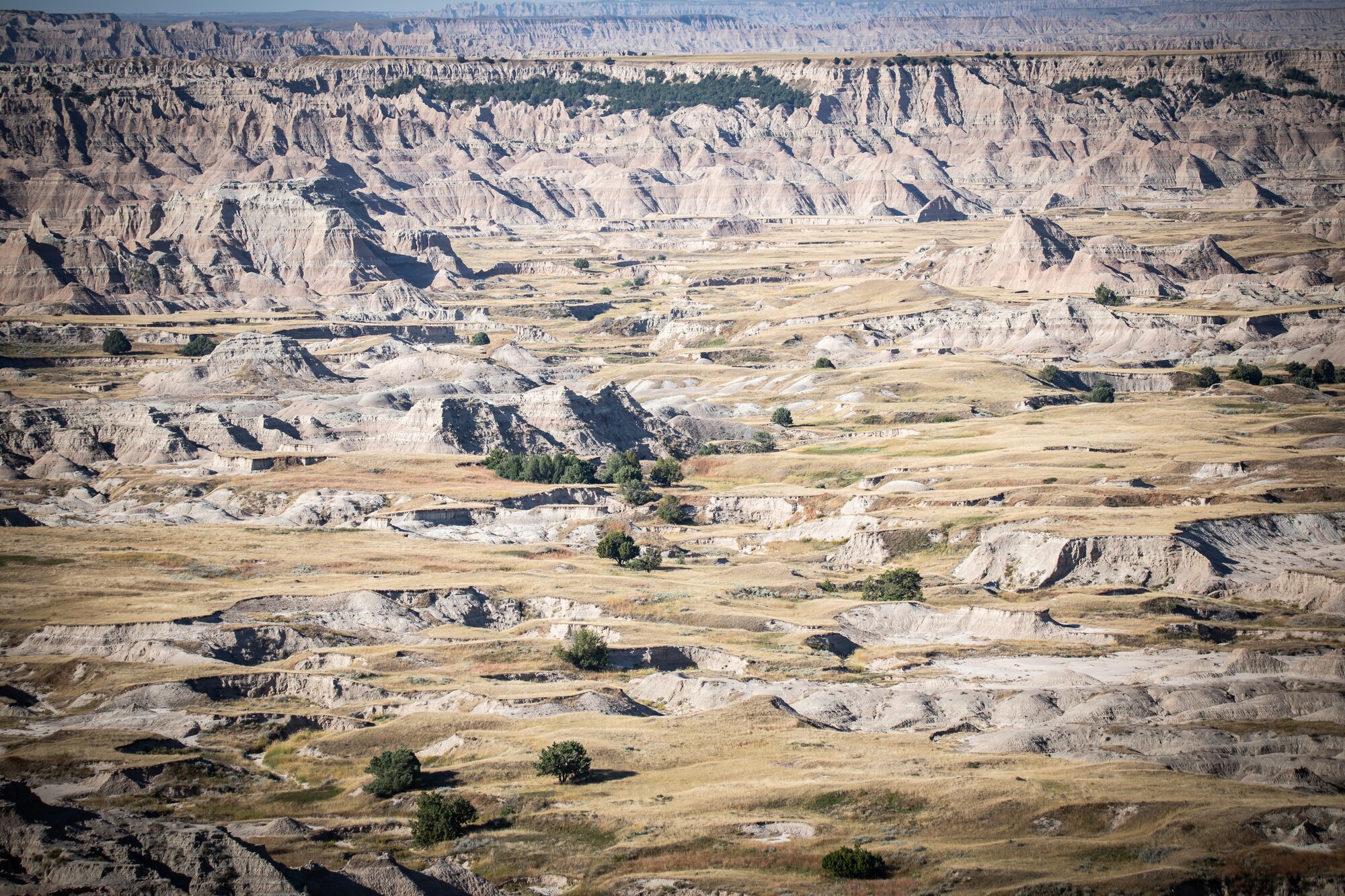 landscape photo of rocky badlands rising over the plain