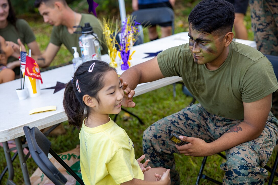 U.S. Marines with Marine Aviation Logistics Squadron 24 (MALS-24), Marine Aircraft Group 24, 1st Marine Aircraft Wing, volunteer at Ahuimanu Elementary School, Ahuimanu, Hawaii, Sept. 23, 2023. The event consisted of Polynesian dance performances, a petting zoo, games, face painting and local food and craft vendors to fundraise for the school. MALS-24 partnered with Ahuimanu Elementary School to celebrate its 50th birthday and enhance community relations. (U.S. Marine Corps photo by 2nd Lt. Hannah Venables)