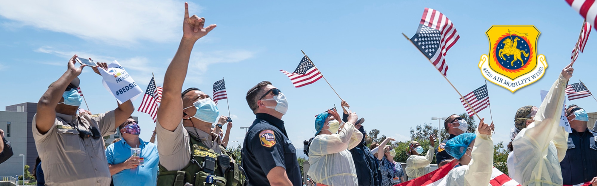 Medical, law enforcement and firefighter personnel wave and cheer as a KC-135 Stratotanker flies over the crowd at the Riverside University Health System Medical Center in Moreno Valley, California on May 14, 2020. The 452nd Air Mobility Wing participated in the #AirForceSalutes portion of #AmericaStrong, honoring local healthcare workers, essential employees, and other first responders on the front line of the battle against COVID-19 with two flyovers. (US Air Force photo by Tech. Sgt. Nick Kibbey)