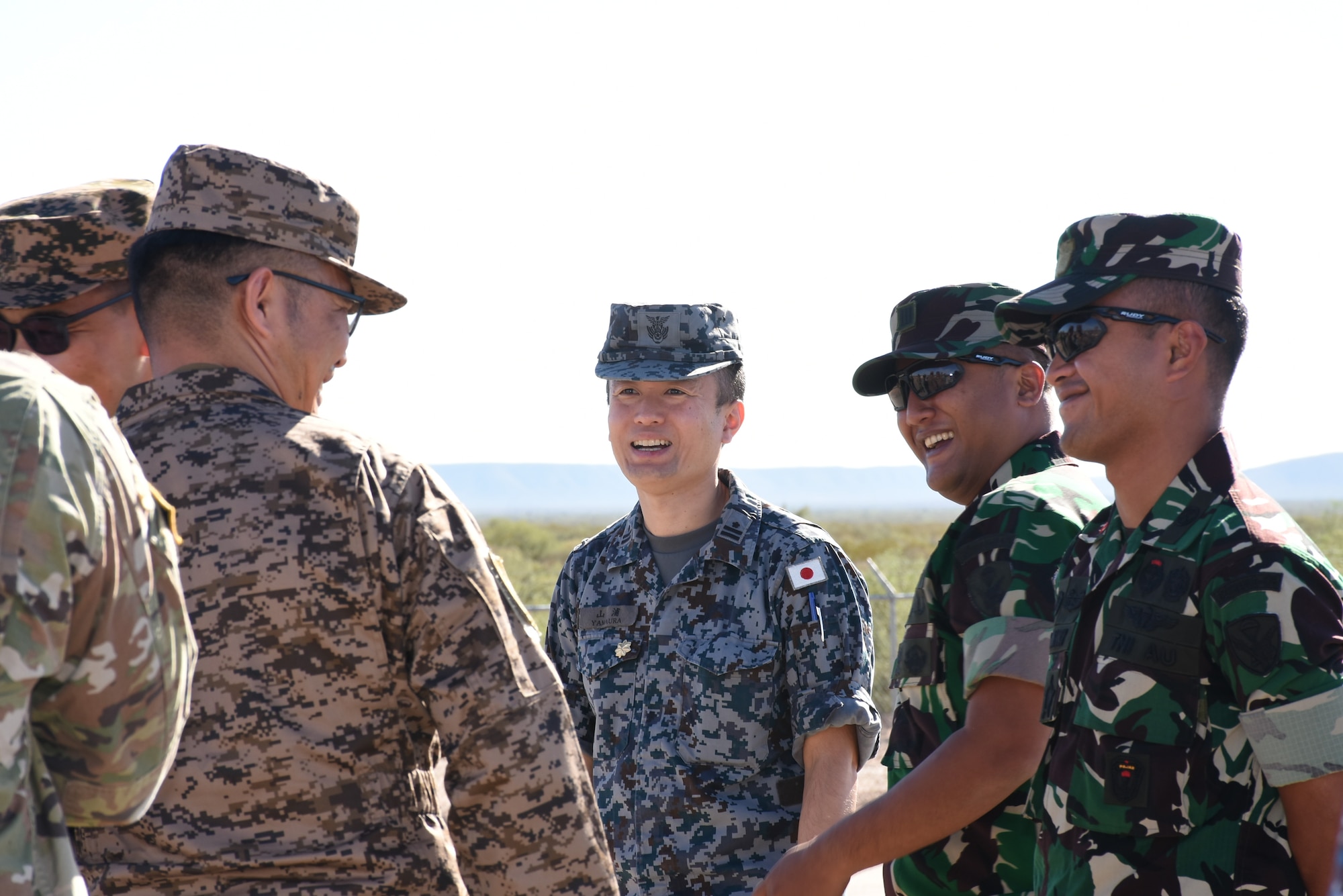 Japan Air Self-Defense Force Maj. Yamaura Masafuni talks with members of the Mongolian Air Force and Indonesian Air Force while waiting for the drones to be released for the JASDF PATRIOT and Japan Ground Self-Defense Force Chu-SAM live engagements on the McGregor Range, El Paso, Texas, September 25-30, 2023. (Courtesy photo)