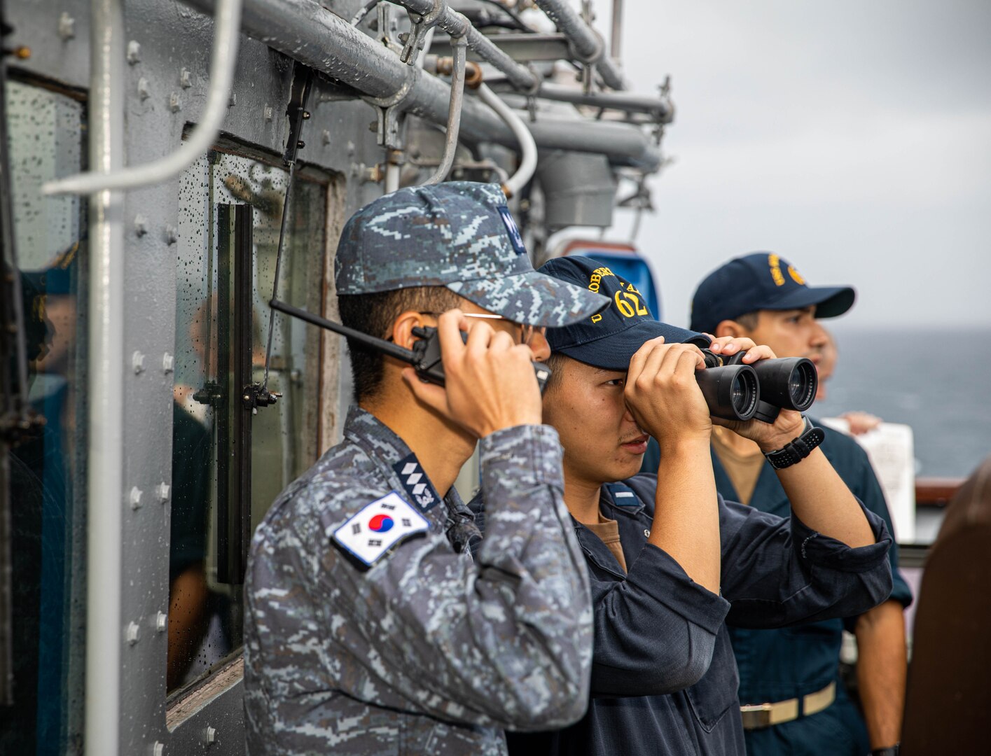 Lt. j.g. Jung Kim, from San Ramon, California observes a replenishment-at-sea with Lt. Jeong Woo Jin on the bridge aboard Ticonderoga-class guided-missile cruiser USS Robert Smalls (CG 62) during a fueling replenishment-at-sea with first-in-class fast-combat support ship ROKS Cheonji (AOE 57), Sept. 26. Robert Smalls is assigned to Commander, Task Force 70 and is participating in a multi-domain bilateral exercise with the Republic of Korea Navy in the U.S. 7th Fleet area of operations. The exercise is taking place near the 70th anniversary of the U.S. and Republic of Korea’s Oct. 1, 1953 Mutual Defense Treaty. (U.S. Navy photo by Mass Communication Specialist 2nd Class RuKiyah Mack).