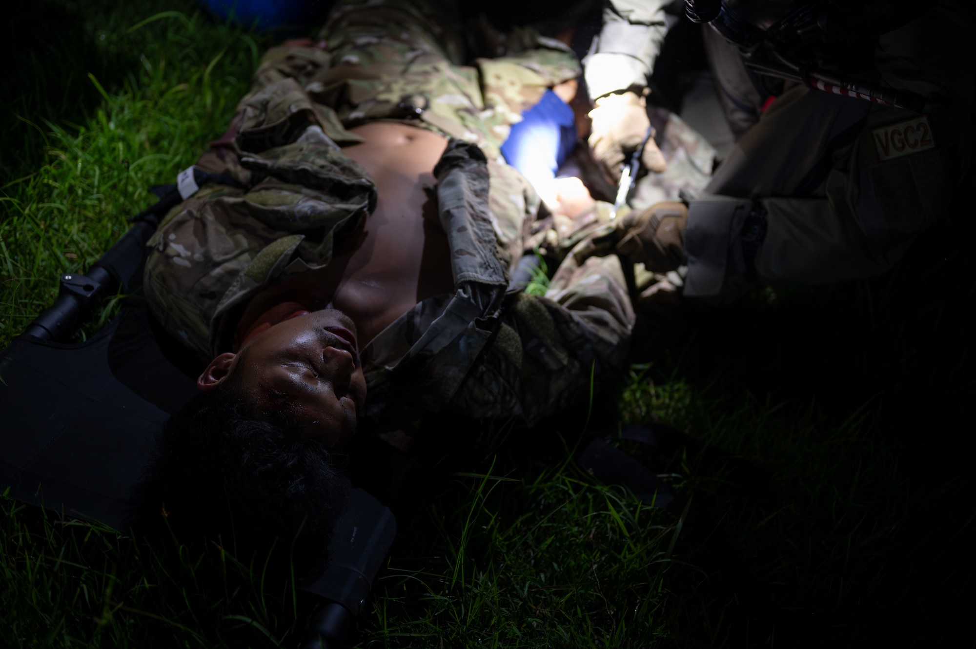 A U.S. Air Force Airman with the 353rd Special Operations Wing removes clothing from an accident victim during a simulated chemical, biological, radiological, nuclear, and explosives mass casualty scenario at Kadena Air Base, Japan, Aug. 17, 2023. The operators were tested on the full spectrum of medical response capabilities using Tactical Combat Casualty Care. TCCC training enhances the skills necessary to efficiently assess and manage a casualty from the point of injury to a higher level of care. (U.S. Air Force photo by Staff Sgt. Jessi Roth)