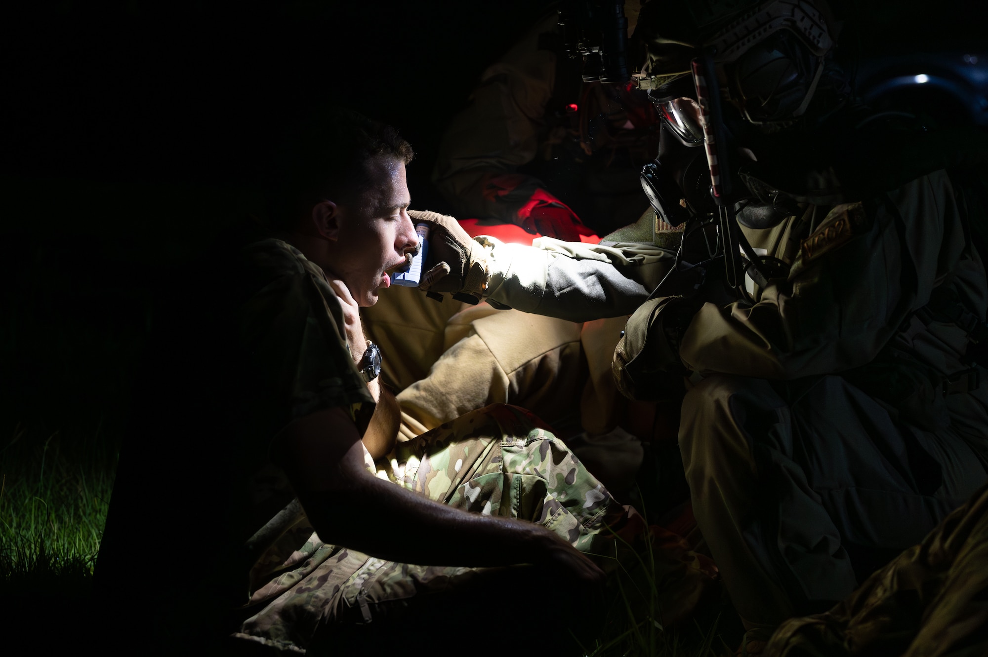 A U.S. Air Force Airman with the 353rd Special Operations Wing cares for a patient involved in a simulated chemical, biological, radiological, nuclear, and explosives mass casualty scenario at Kadena Air Base, Japan, Aug. 17, 2023. The operators were tested on the full spectrum of medical response capabilities using Tactical Combat Casualty Care. TCCC training increases Special Operations Forces’ rapid response capabilities in real-world contingencies. (U.S. Air Force photo by Staff Sgt. Jessi Roth)