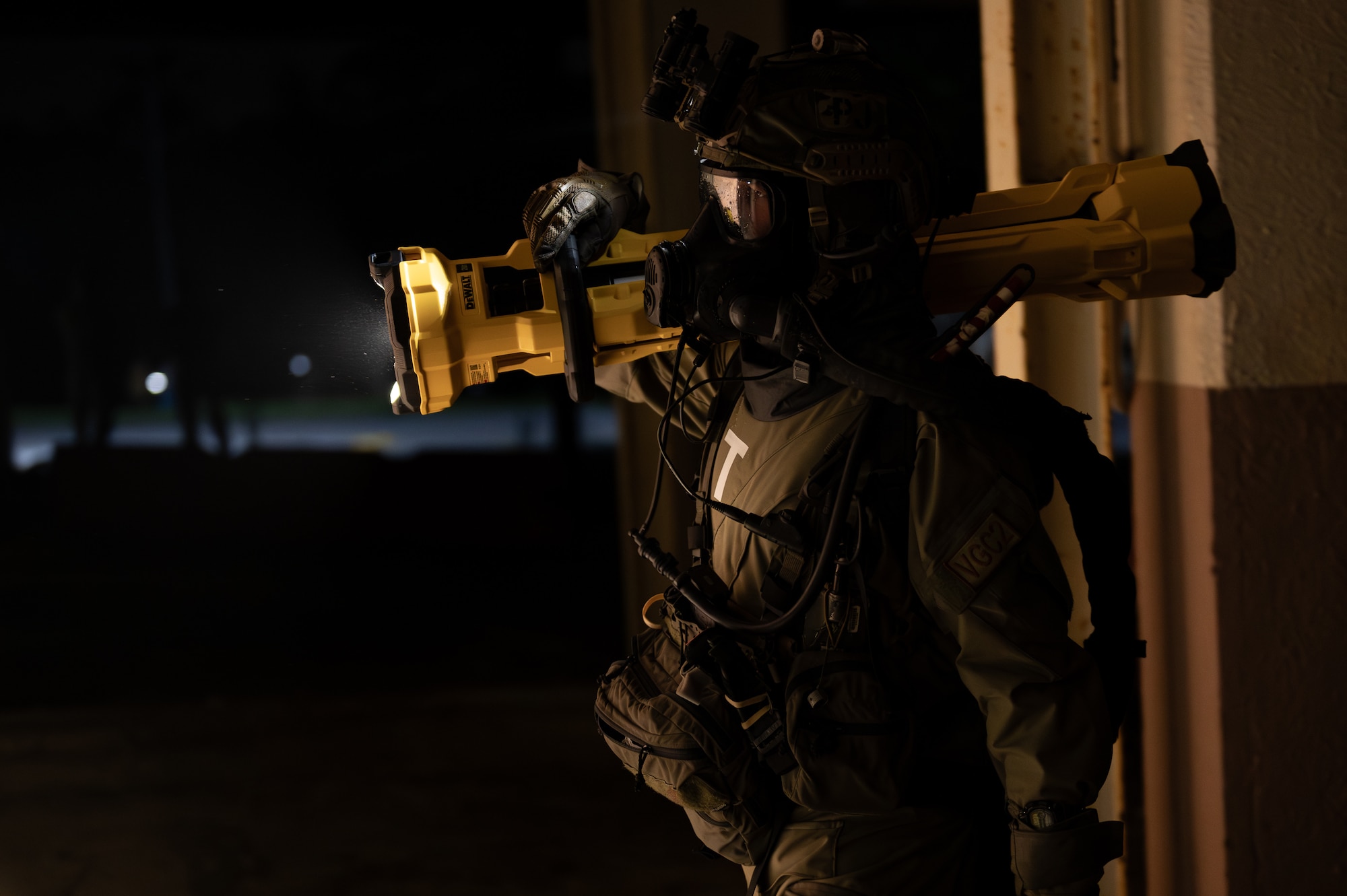 A U.S. Air Force Airman with the 353rd Special Operations Wing prepares to enter an accident scene during a simulated chemical, biological, radiological, nuclear, and explosives mass casualty drill at Kadena Air Base, Japan, Aug. 17, 2023. The functional exercise was conducted to bolster operational capability through a CBRNE mission to test the medical response and quick decision-making capabilities of the operators during a realistic simulated emergency with multiple casualties. (U.S. Air Force photo by Staff Sgt. Jessi Roth)