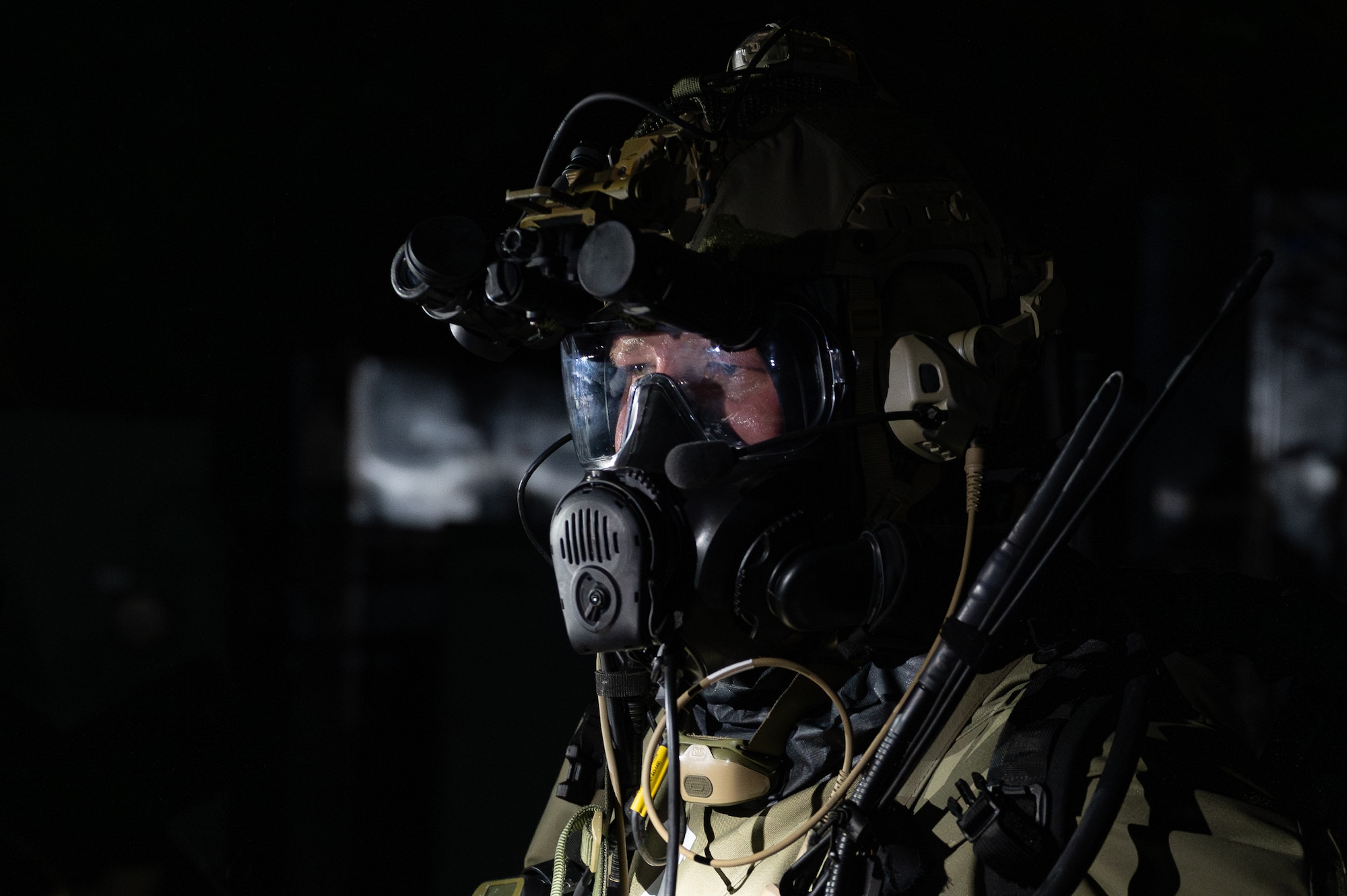 A U.S. Air Force Airman with the 353rd Special Operations Wing dons full Mission Oriented Protective Posture gear during a simulated chemical, biological, radiological, nuclear, and explosives mass casualty scenario at Kadena Air Base, Japan, Aug. 17, 2023. The functional exercise was conducted to bolster operational capability through a CBRNE mission to test the medical response and quick decision-making capabilities of the operators during a realistic simulated emergency with multiple casualties. (U.S. Air Force photo by Staff Sgt. Jessi Roth)