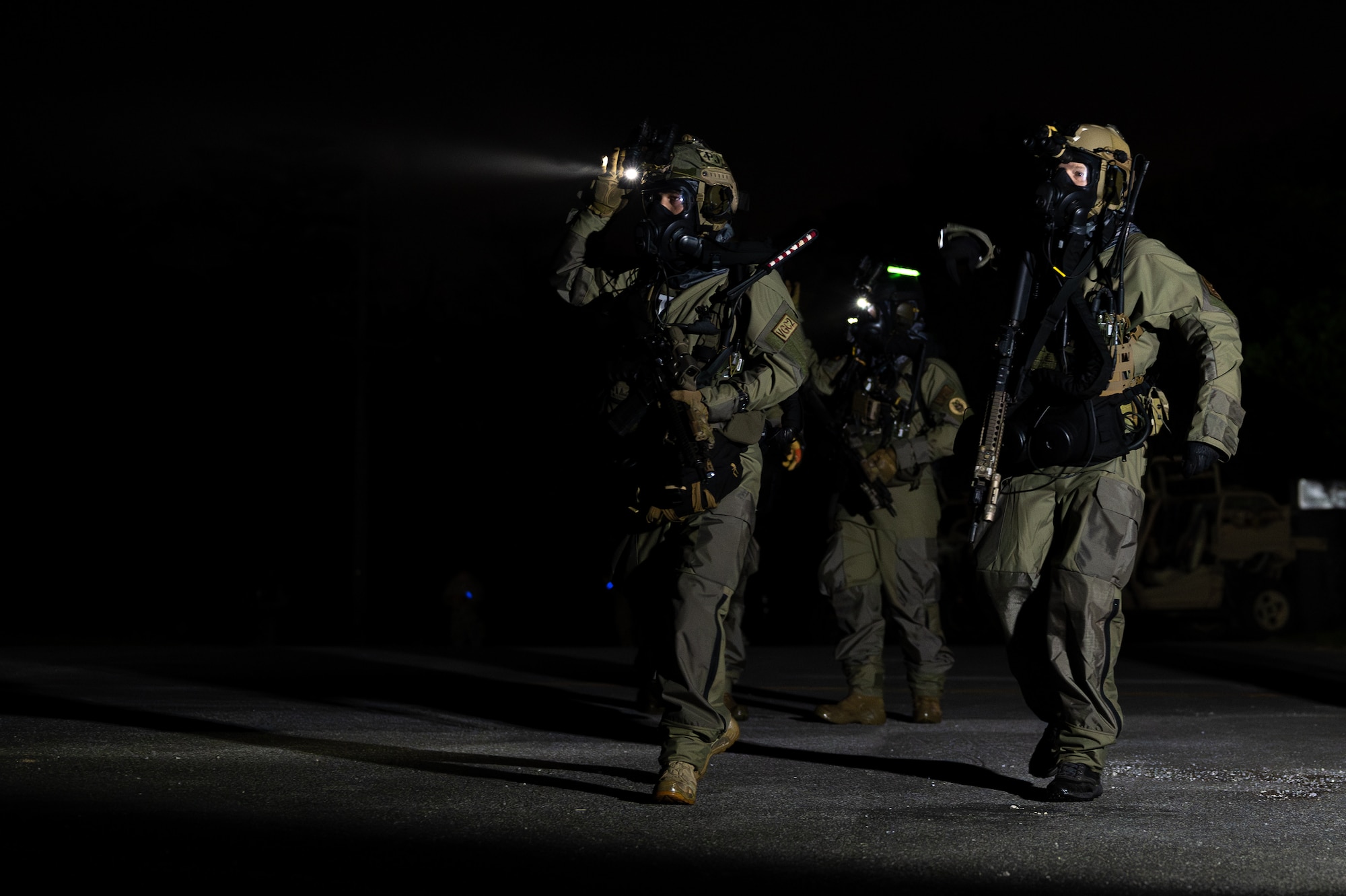 U.S. Air Force Airmen with the 353rd Special Operations Wing prepare to enter an accident scene during a simulated chemical, biological, radiological, nuclear, and explosives mass casualty drill at Kadena Air Base, Japan, Aug. 17, 2023. The operators were evaluated on their rapid action, decision making, and technical performance of medical interventions during a CBRNE scenario-based training. (U.S. Air Force photo by Staff Sgt. Jessi Roth)