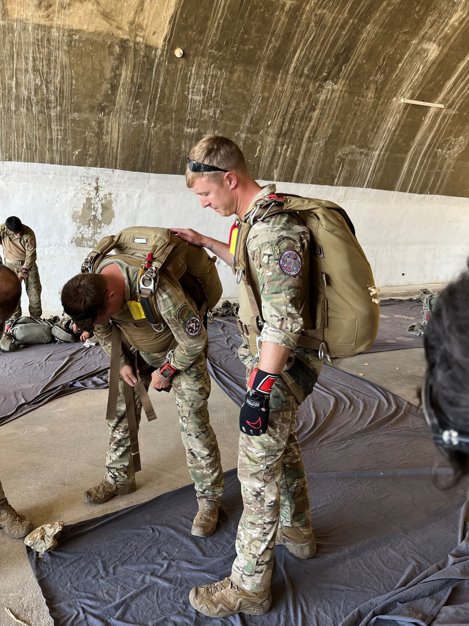Tech. Sgt. Robert Gregory, SERE Flight Chief, 412th OSS oversees an equipment check with a fellow Airman during the Resolute Sentinel 2023 exercise in July of 2023 in Peru. With a focus on combining combat training and civil-military operations, Resolute Sentinel 2023 serves as a vital platform to enhance cooperation between the U.S. and its partner nations.  (U.S. Air Force photo by 412th OSS)