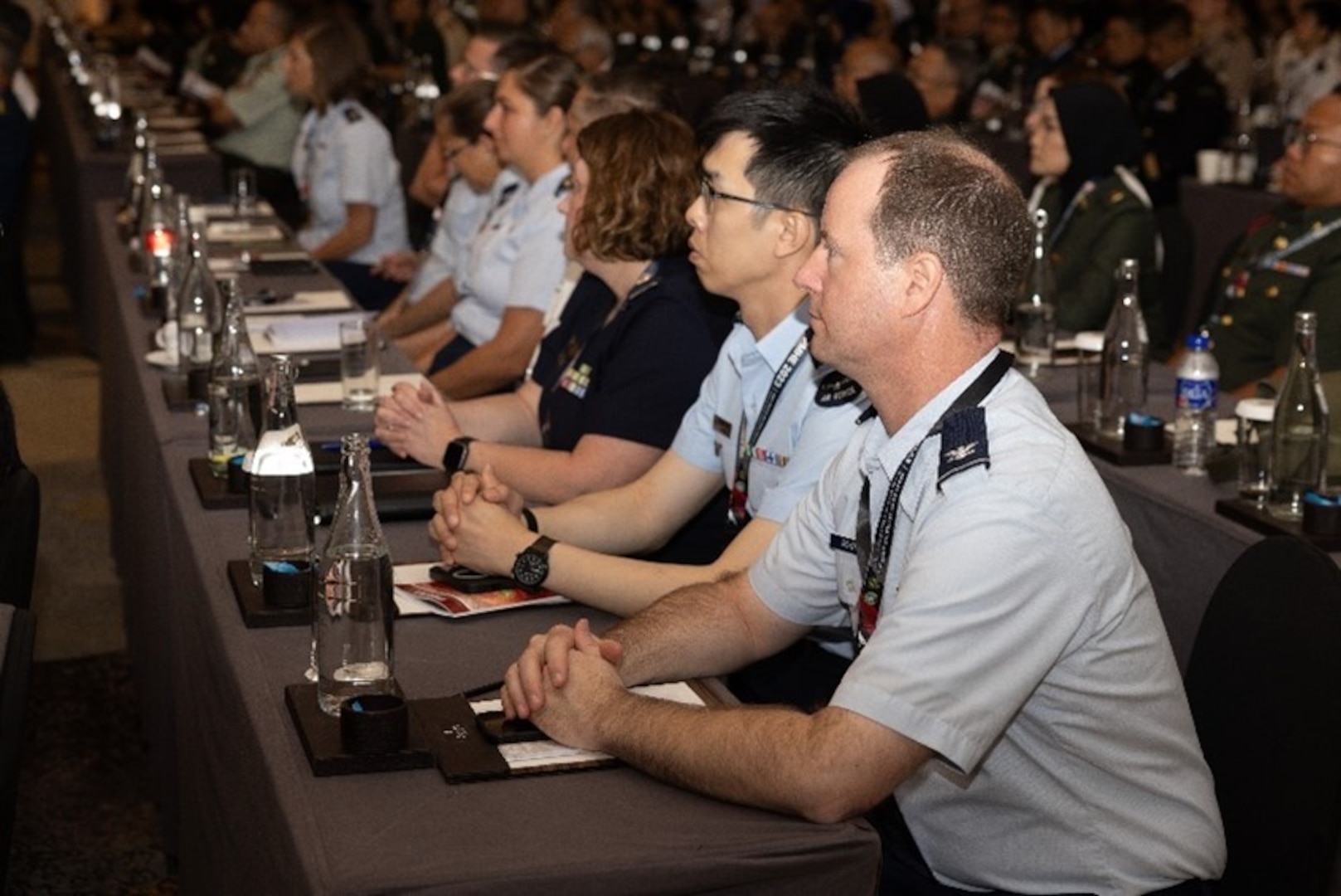 Image of service members listening to a presentation.