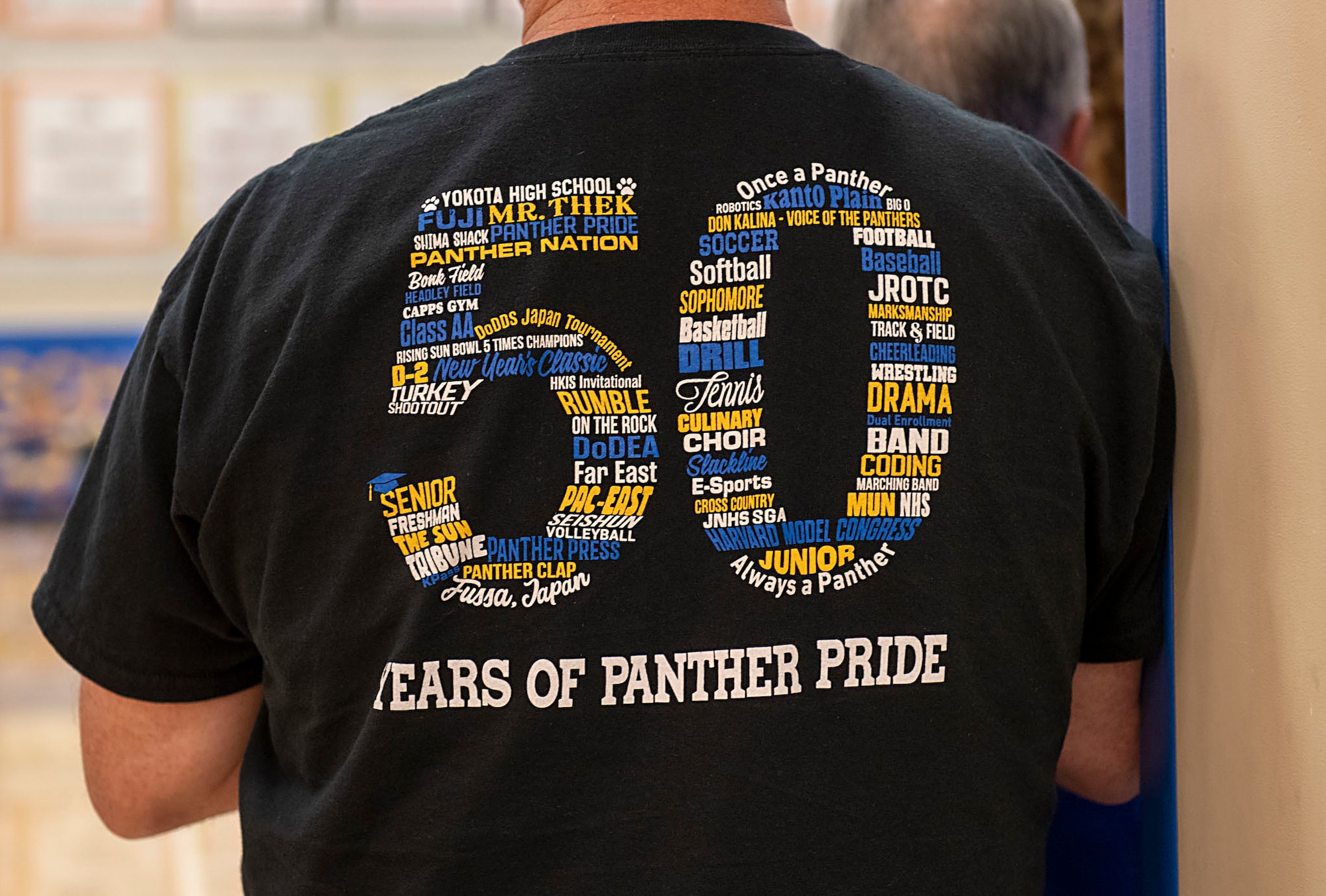 A Yokota High School alumni wears a 50th Anniversary shirt titled “50 years of Panther Pride”