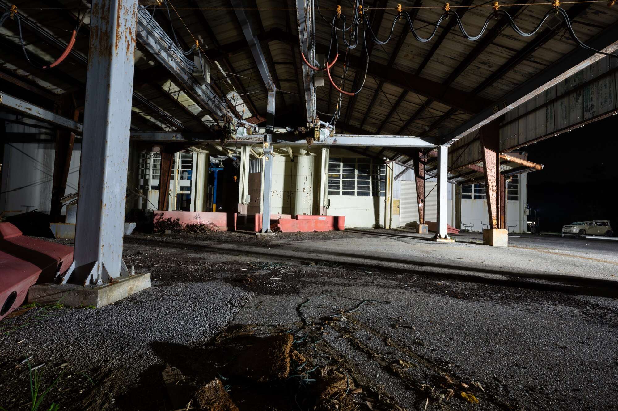 An abandoned factory is the scene of a simulated chemical, biological, radiological, nuclear, and explosives mass casualty drill at Kadena Air Base, Japan, Aug. 17, 2023. Airmen with the 353rd Special Operations Wing were evaluated on their rapid action, decision making, and technical performance of medical interventions during the CBRNE scenario-based training. (U.S. Air Force photo by Staff Sgt. Jessi Roth)