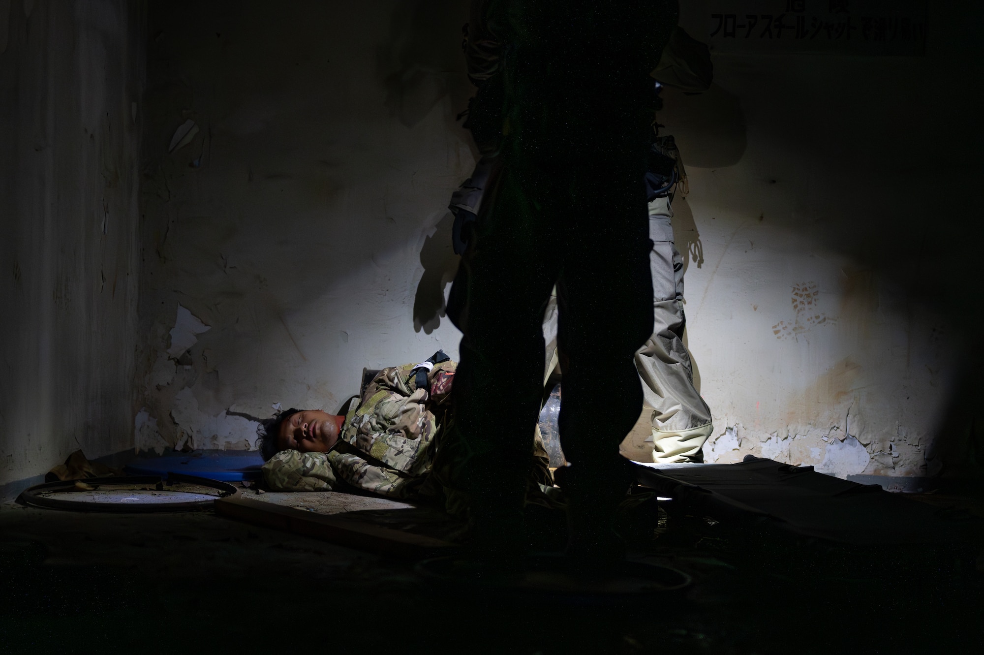 U.S. Air Force Airmen with the 353rd Special Operations Wing approach an accident victim during a simulated chemical, biological, radiological, nuclear, and explosives mass casualty drill at Kadena Air Base, Japan, Aug. 17, 2023. The operators were evaluated on their rapid action, decision making, and technical performance of medical interventions during the CBRNE scenario-based training. (U.S. Air Force photo by Staff Sgt. Jessi Roth)