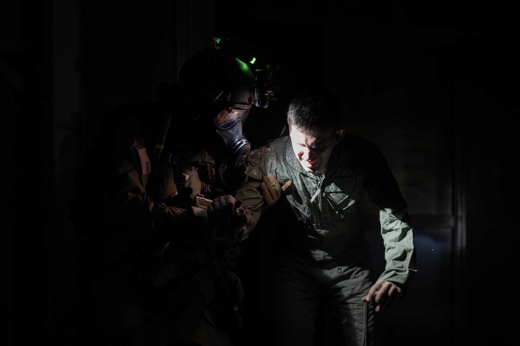 A U.S. Air Force Airman with the 353rd Special Operations Wing assists an accident victim during a simulated chemical, biological, radiological, nuclear, and explosives mass casualty drill at Kadena Air Base, Japan, Aug. 17, 2023. The operators were evaluated on their rapid action, decision making, and technical performance of medical interventions during the CBRNE scenario-based training. (U.S. Air Force photo by Staff Sgt. Jessi Roth)