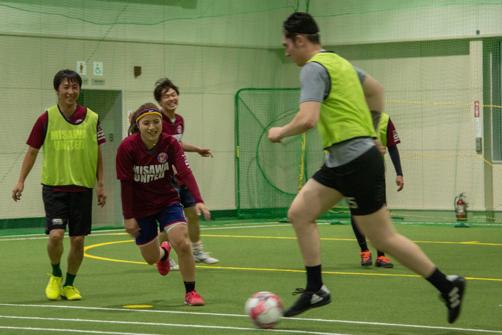 A group of soccer players practice at in indoor soccer field in Misawa.