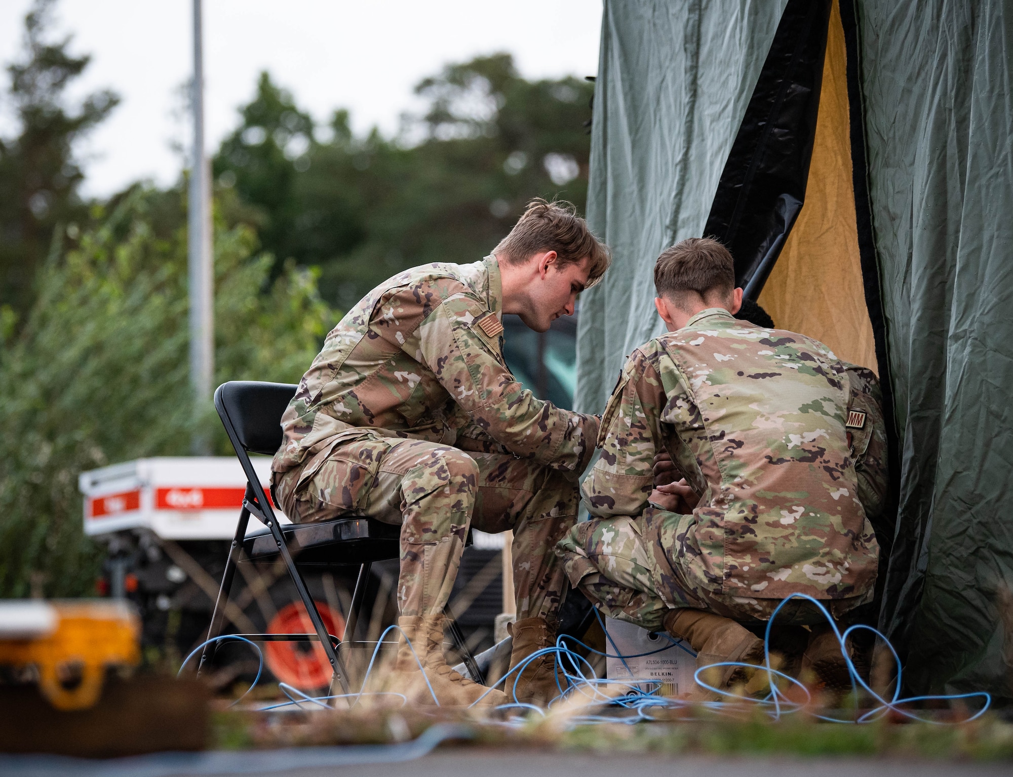 Airmen assigned to the 1st Combat Communications Squadron set up internet access for participants of Operation EASY MAC, an Agile Combat Employment exercise at Ramstein Air Base, Germany, Sept. 19, 2023. According to Air Force Doctrine, ACE is a proactive and reactive operational scheme of maneuver executed within threat timelines to increase survivability while generating combat power. (U.S. Air Force photo by Senior Airman Jared Lovett)