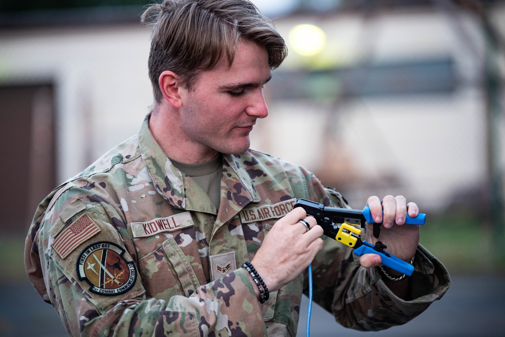 U.S. Air Force Airman 1st Class Seth Kidwell, 1st Combat Communications Squadron tactical communications technician, crimps an ethernet cable during Operation EASY MAC at Ramstein Air Base, Germany, Sept. 19, 2023. Operation EASY MAC is a three-day, cross-organization exercise that allows the 693rd Intelligence Support Squadron to demonstrate their intelligence capabilities in an austere environment. (U.S. Air Force photo by Senior Airman Jared Lovett)