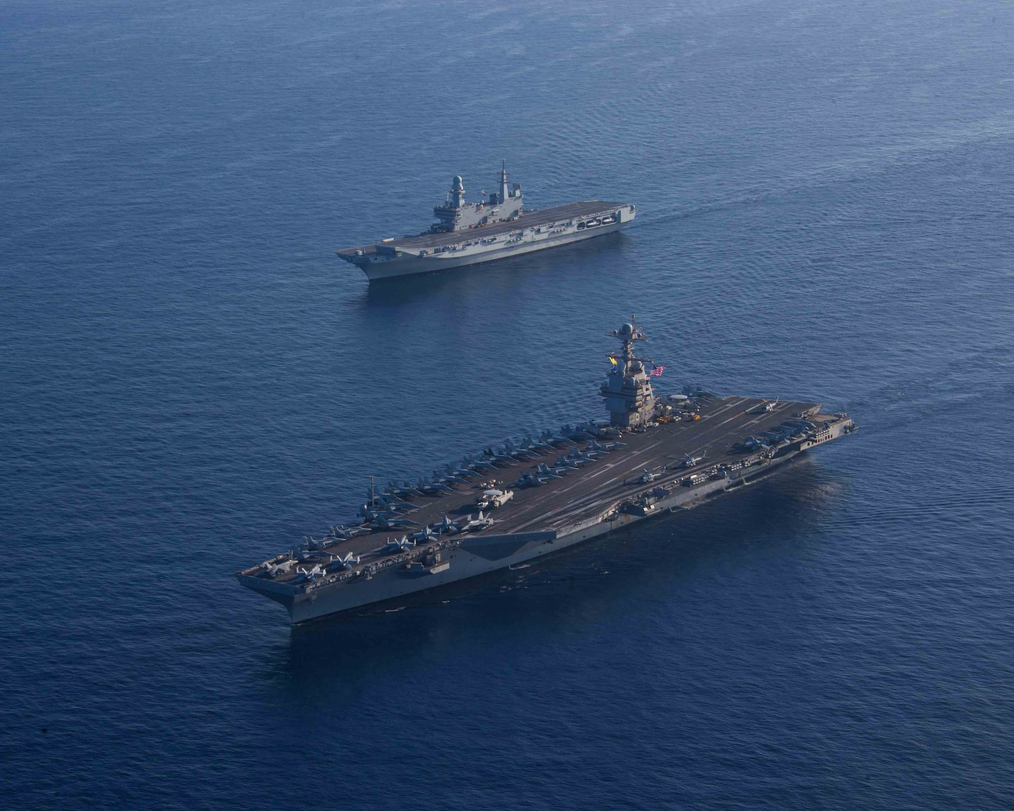 The world's largest aircraft carrier USS Gerald R. Ford (CVN 78) and Italian Navy aircraft carrier ITS Cavour (C 550), steam in formation in the Ionian Sea, Oct. 4, 2023 Gerald R. Ford is the U.S. Navy's newest and most advanced aircraft carrier, representing a generational leap in the U.S. Navy's capacity to project power on a global scale. The Gerald R. Ford Carrier Strike Group is on a scheduled deployment in the U.S. Naval Forces Europe area of operations, employed by U.S. Sixth Fleet to defend U.S., allied, and partner interests. (U.S. Navy photo by Mass Communication Specialist 2nd Class Jacob Mattingly)