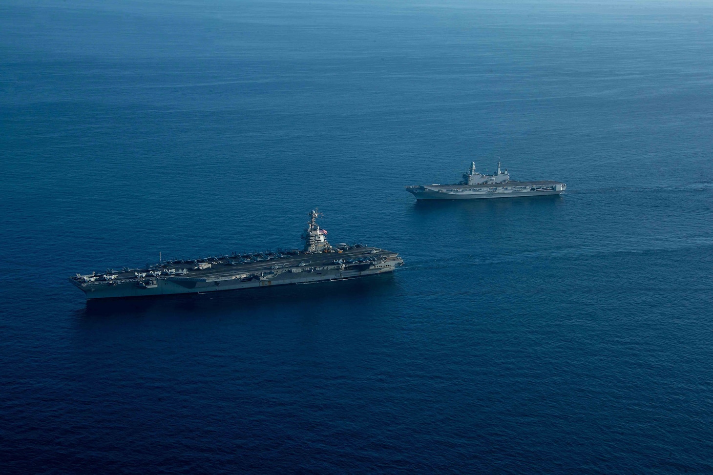 The world's largest aircraft carrier USS Gerald R. Ford (CVN 78) and Italian Navy aircraft carrier ITS Cavour (C 550), steams in the Ionian Sea, Oct. 04, 2023 Gerald R. Ford is the U.S. Navy's newest and most advanced aircraft carrier, representing a generational leap in the U.S. Navy's capacity to project power on a global scale. The Gerald R. Ford Carrier Strike Group is on a scheduled deployment in the U.S. Naval Forces Europe area of operations, employed by U.S. Sixth Fleet to defend U.S., allied, and partner interests (U.S. Navy photo by Mass Communication Specialist 3rd Class Maxwell Orlosky)