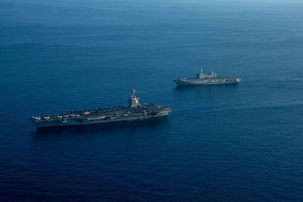 The world's largest aircraft carrier USS Gerald R. Ford (CVN 78) and Italian Navy aircraft carrier ITS Cavour (C 550), steams in the Ionian Sea, Oct. 04, 2023 Gerald R. Ford is the U.S. Navy's newest and most advanced aircraft carrier, representing a generational leap in the U.S. Navy's capacity to project power on a global scale. The Gerald R. Ford Carrier Strike Group is on a scheduled deployment in the U.S. Naval Forces Europe area of operations, employed by U.S. Sixth Fleet to defend U.S., allied, and partner interests (U.S. Navy photo by Mass Communication Specialist 3rd Class Maxwell Orlosky)