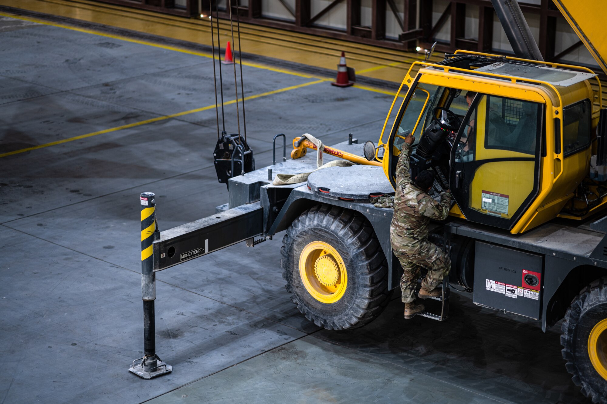 Airman climbing into a crane