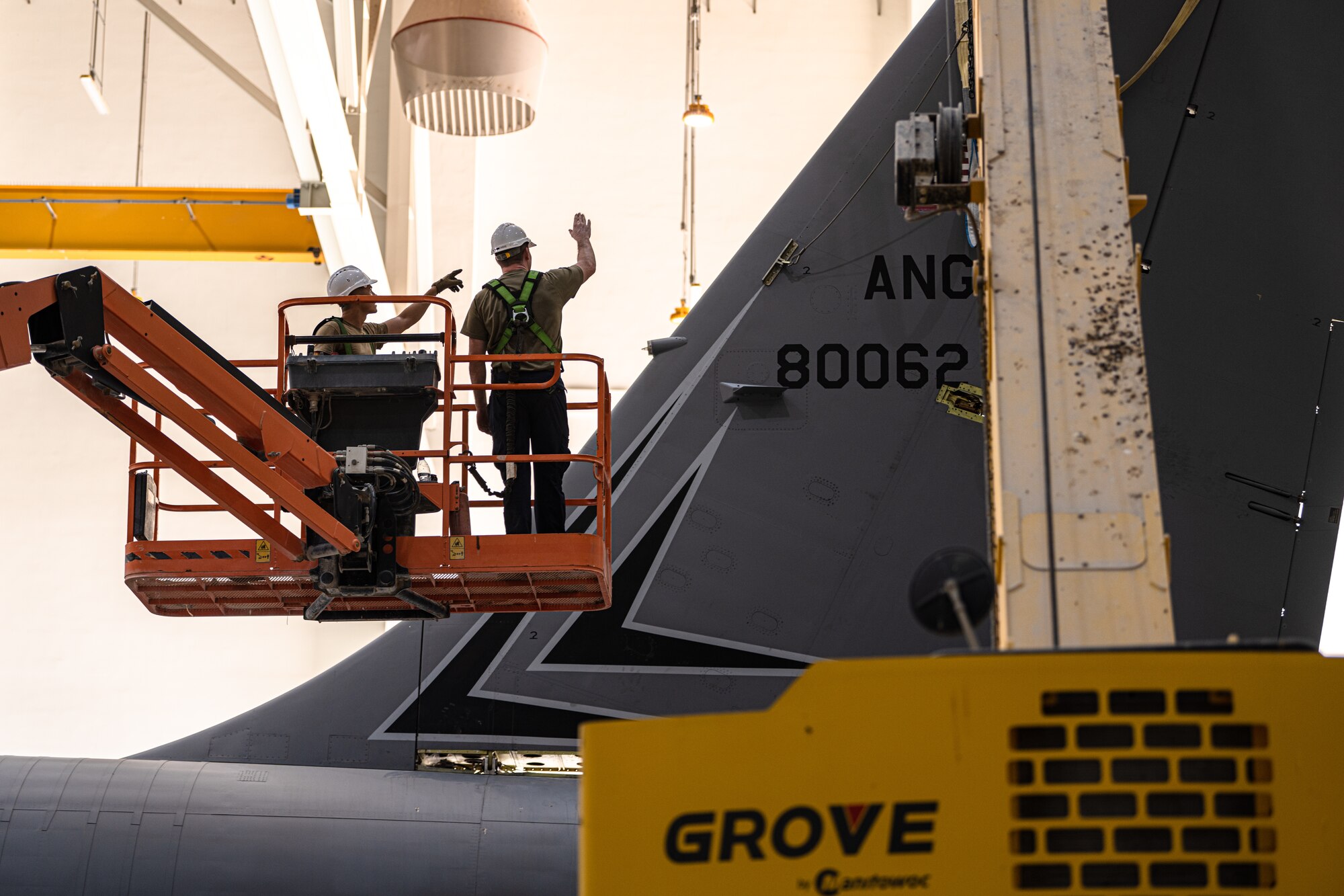 Airmen removing an aircraft tail fin