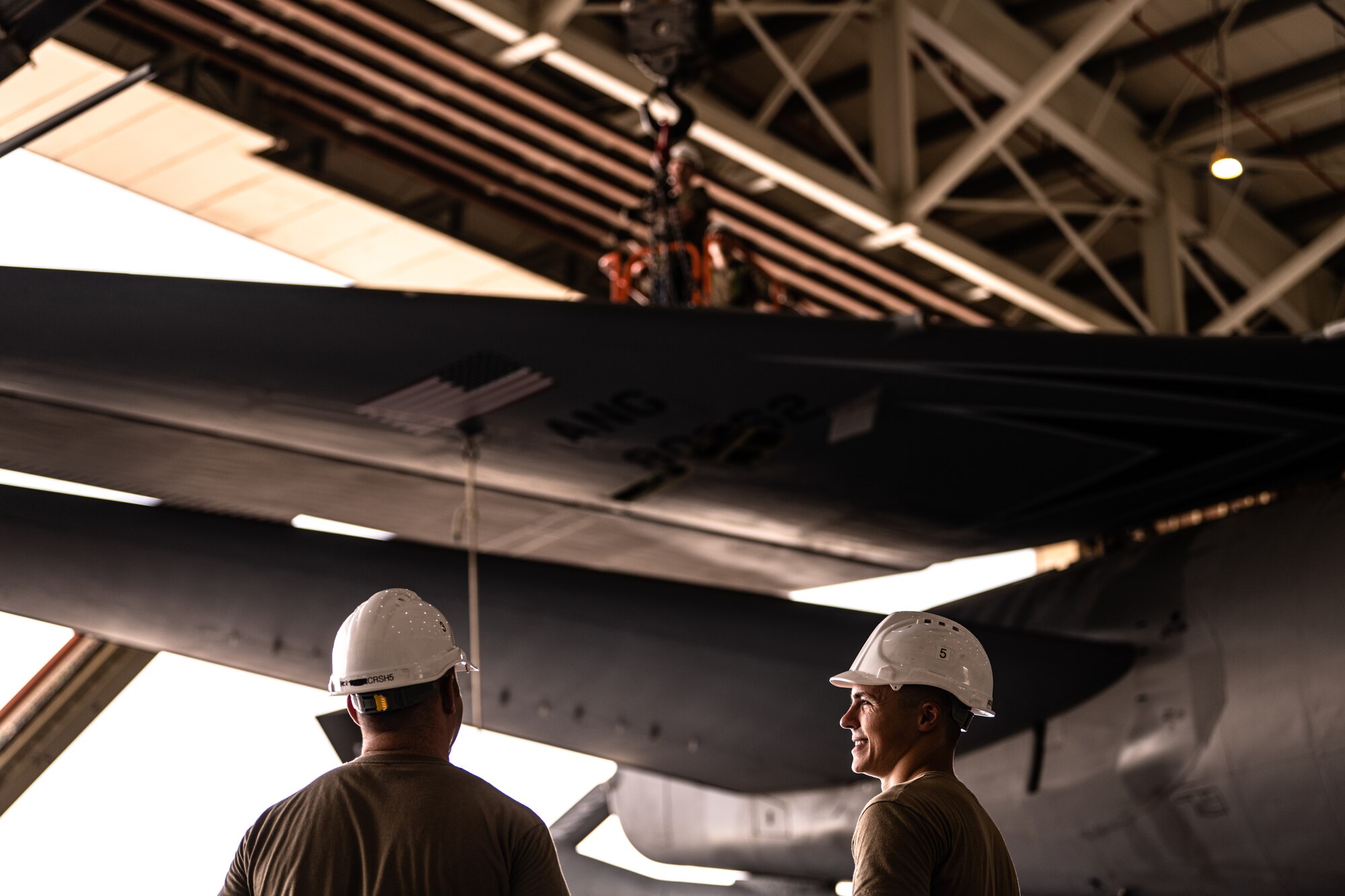 Airmen removing an aircraft tail fin