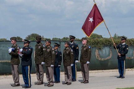 Service members stand in formation