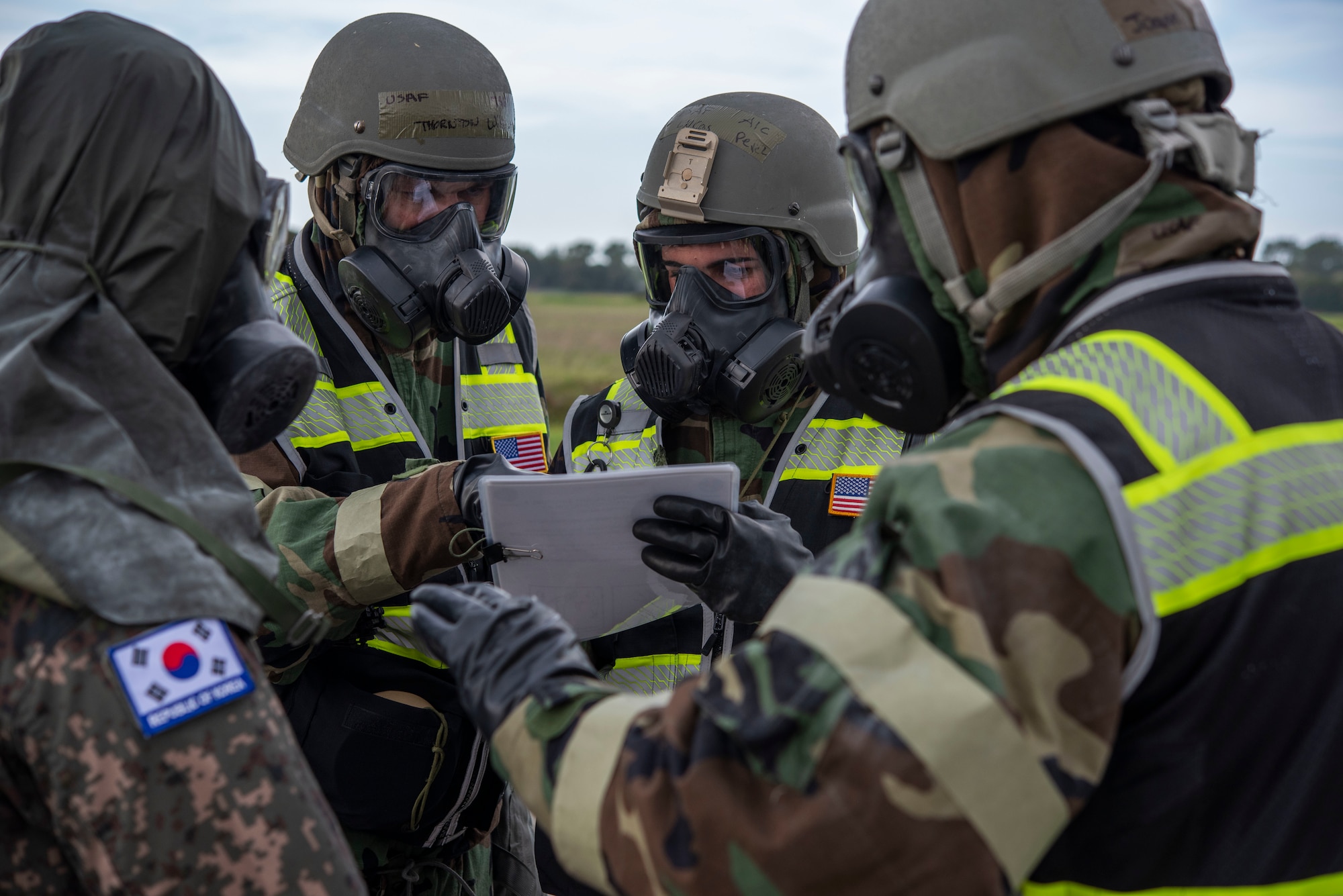 Four men discuss decontamination processes