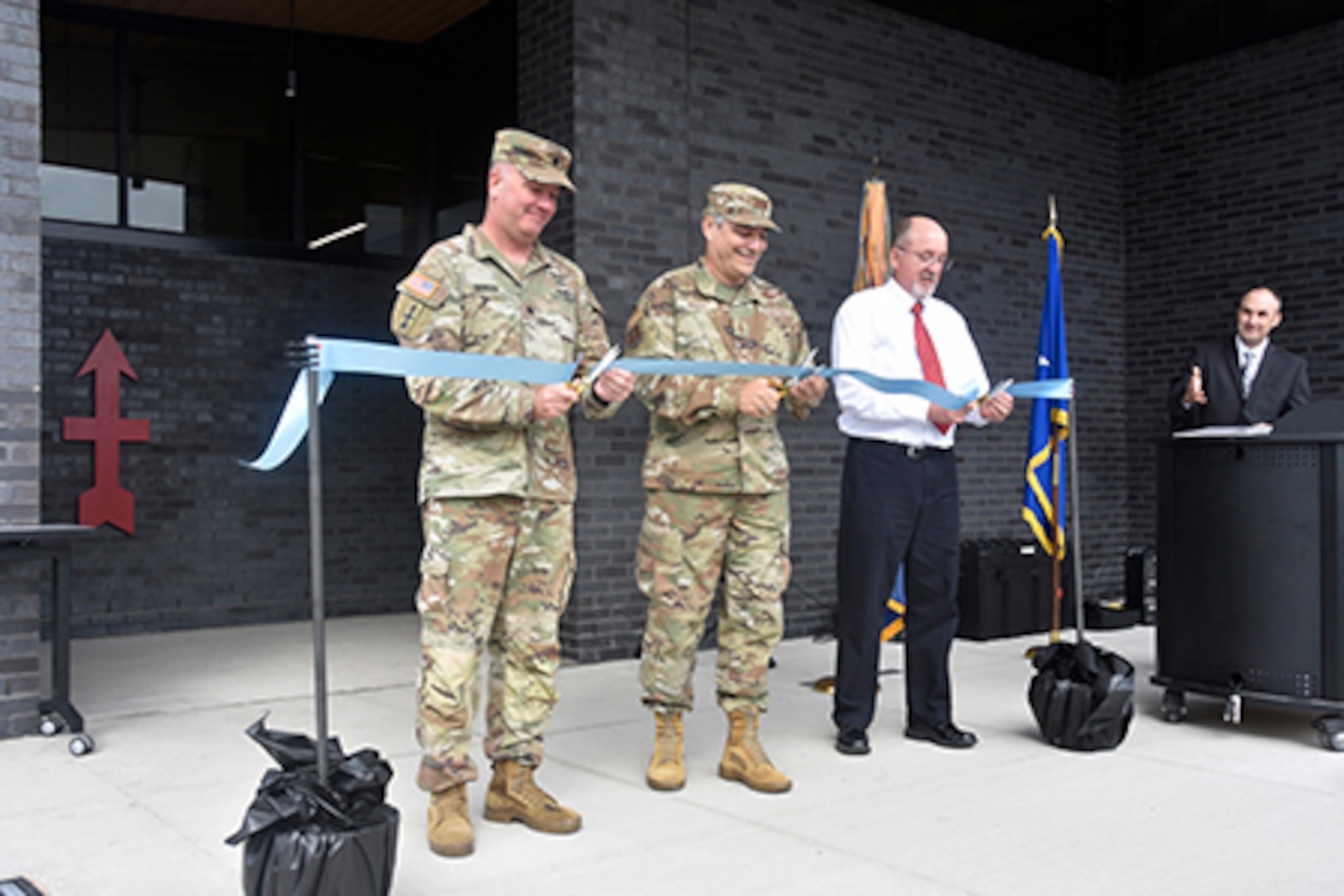 Lt. Col. Bill Benson, commander of the Wisconsin Army National Guard’s 2nd Battalion, 127th Infantry Regiment, joins Maj. Gen. Paul Knapp, Wisconsin’s adjutant general, and Dan Durig, a Wisconsin Department of Military Affairs civil engineer, in cutting a ribbon to signify the grand opening of the Wisconsin Army National Guard armory in Appleton, Wis., Sept. 28.