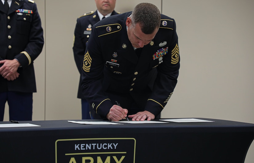 1st Sgt. Josh Varney, with Bravo Company, signs his recruiting commitment for the next years recruiting mission during a signing ceremony at the Bowman Readiness Center in Louisville, Ky., Sept. 29, 2023
