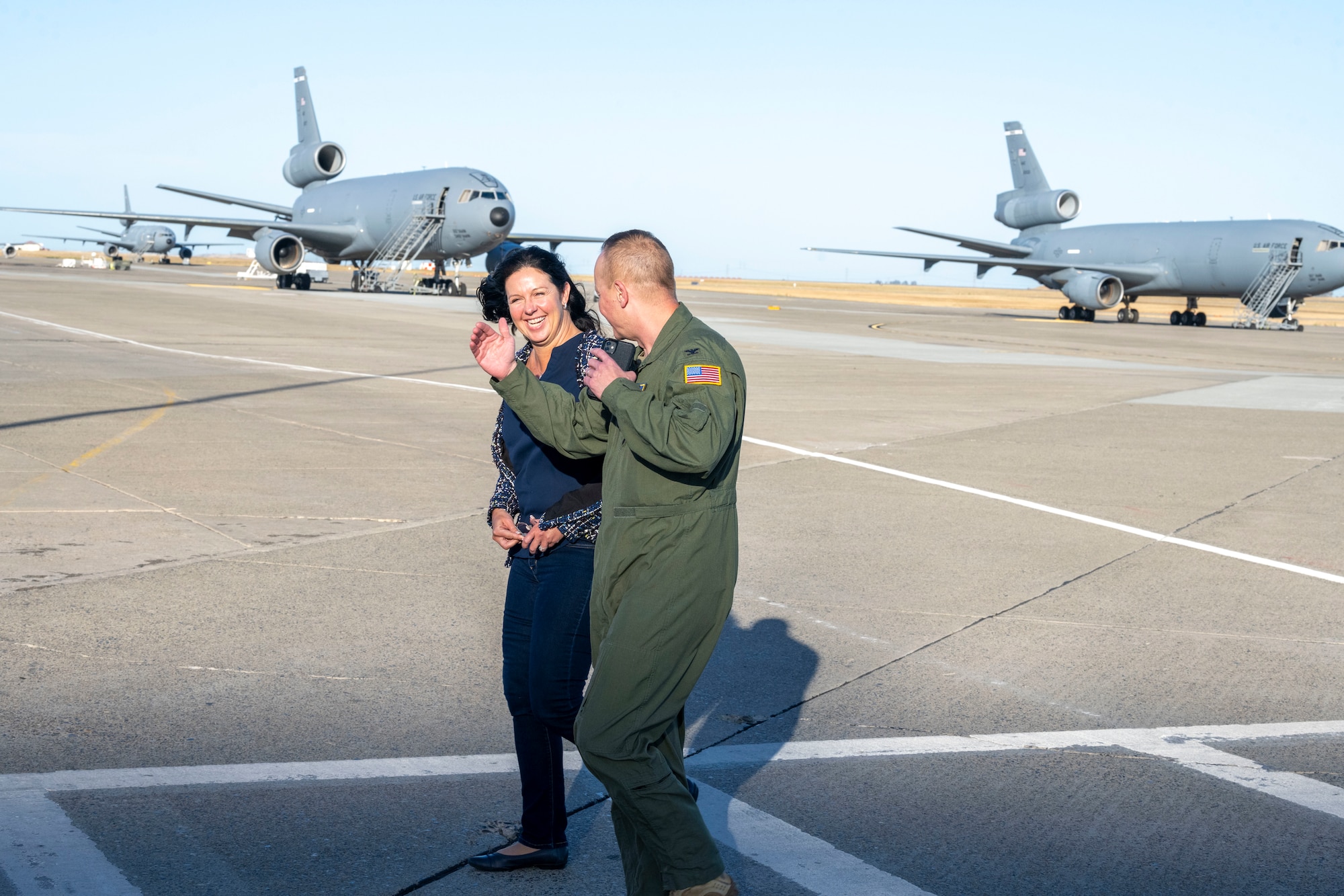 Man walks with woman on flight-line.