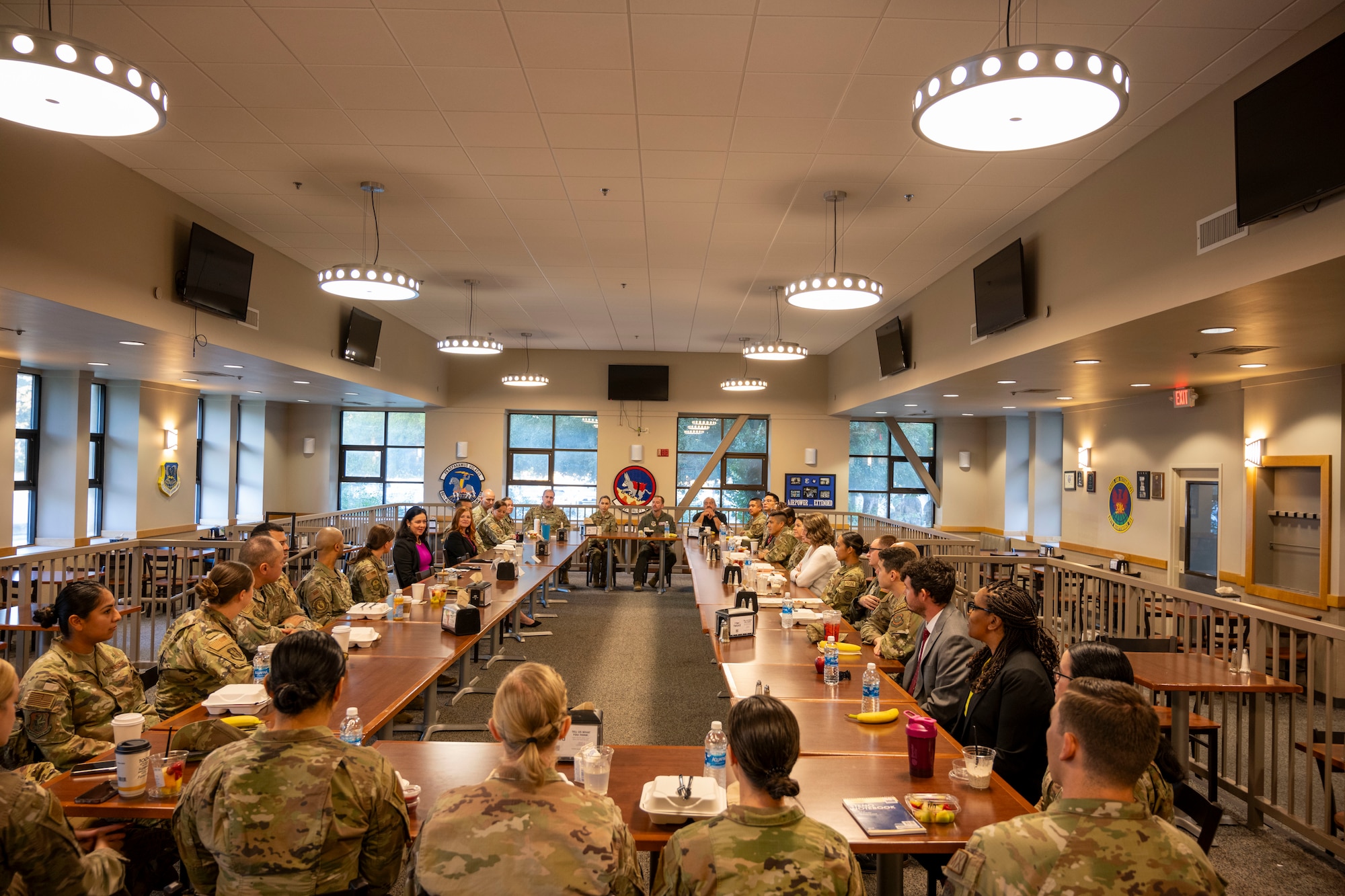 A group of people sit around a table for meal and discussion.