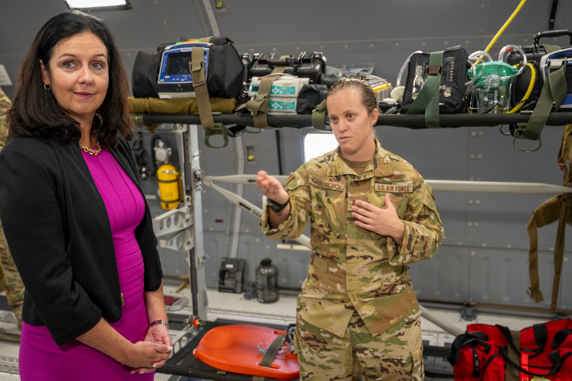 Two women stand on plane for demonstration of medical equiptment.