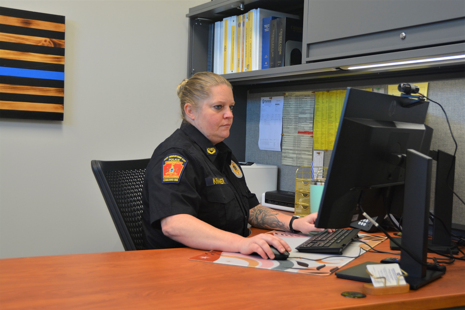 Chief Devan Kramer works at her desk inside the new police station that opened recently at Fort Indiantown Gap. The new station replaces two World War II-era buildings the police department had been using. (Pennsylvania National Guard photo by Brad Rhen)