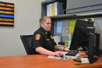 Chief Devan Kramer works at her desk inside the new police station that opened recently at Fort Indiantown Gap. The new station replaces two World War II-era buildings the police department had been using. (Pennsylvania National Guard photo by Brad Rhen)