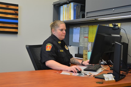 Chief Devan Kramer works at her desk inside the new police station that opened recently at Fort Indiantown Gap. The new station replaces two World War II-era buildings the police department had been using. (Pennsylvania National Guard photo by Brad Rhen)