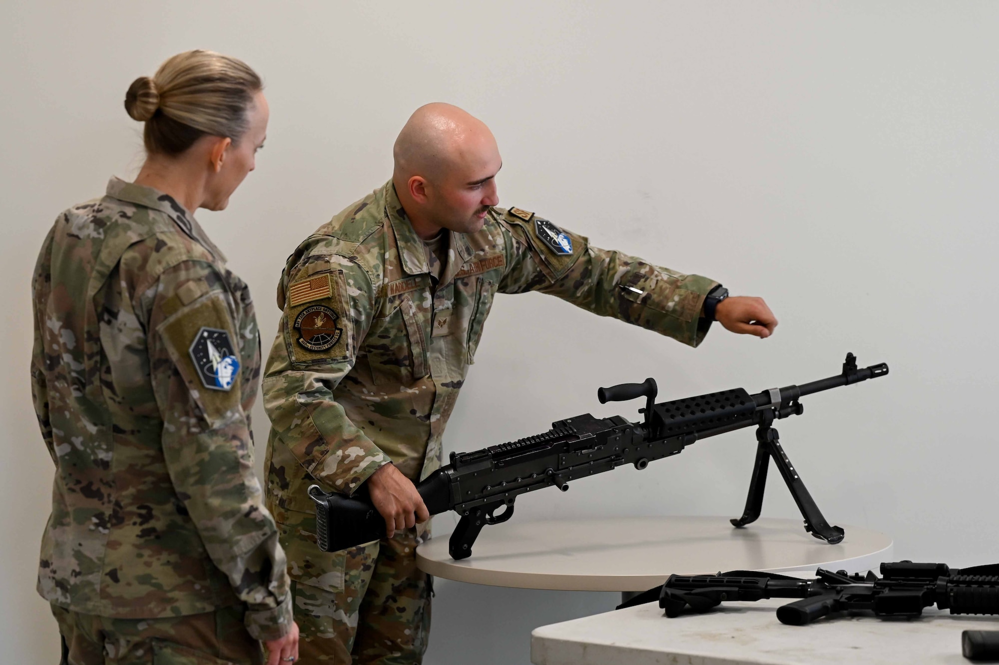 Man shows woman features on a weapon