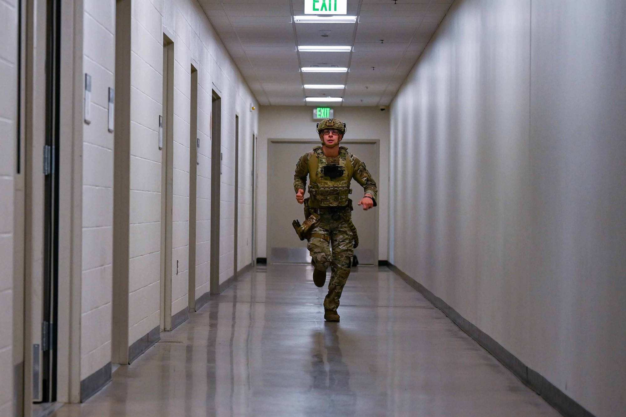 460th Security Forces Squadron member runs down hallway