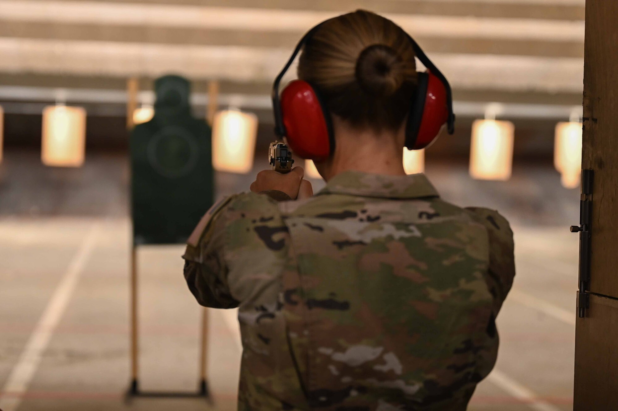 Woman aims weapon at target