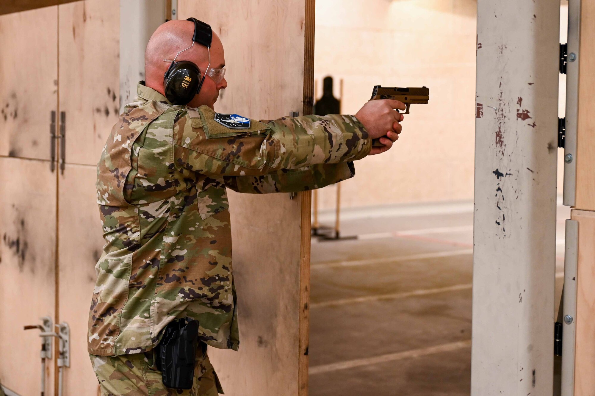 Man aims weapon at a target