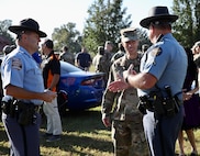 CCoE Commanding General Maj. Gen. Paul Stanton talks with members of the Georgia State Patrol and Columbia County Sheriff's Office during the CCoE's DUI awareness day to promote positive behaviors and demonstrate the harms of driving impaired.