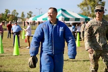 Command Sergeant Major Michael Starrett wears the 'dog suit' to demonstrate the ability of military working dogs.